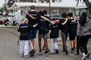 A candid shot of the KMMA martial arts students walking as a group, showcasing the camaraderie and supportive "tribe" culture of the program.