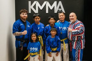 Grandmaster Del Castillo and Shihan Winston pose with a family that just received their belt promotions. It is a father and his four young children.