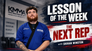 Promotional graphic titled "Lesson of the Week: The Next Rep with Shihan Winston." Featuring Shihan Winston Del Castillo in a blue martial arts uniform and black belt standing in a Krav Maga Martial Arts dojo, with text overlays and core values—Confidence, Discipline, Respect, Leadership—visible on the wall behind him
