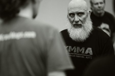 Close up black and white photo of Shihan Thomas at Krav Camp.
