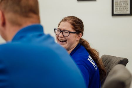 Sensei Allie smiles during a staff meeting.